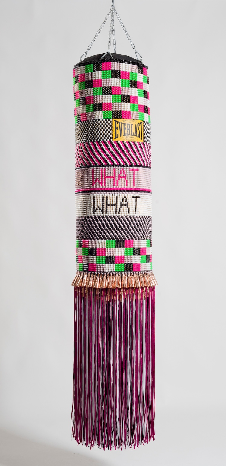 Jeffrey Gibson, Mississippi Band of Choctaw Indians and of Cherokee descentWhat We Want, What We Need, 2014 Found punching bag, glass beads, artificial sinew, copper jingles, nylon fringe, and steel chain 71 in x 14 in x 14 in. Crystal Bridges Museum of American Art, Bentonville, Arkansas, 2015.13.