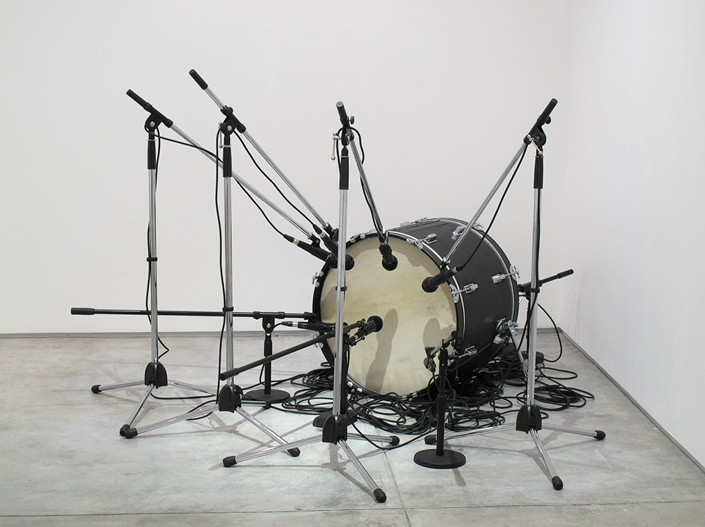 Jamal Cyrus, Untitled (Grand Verbalizer What Time Is It?), 2010. Drum, leather, microphones, mic stands, cables, speaker. 78 × 67 × 45 1/2 in. (198.1 × 170.2 × 115.6 cm). Collection of Ric Whitney and Tina Perry Whitney. Photo: Michael O’Brien, Inman Gallery, Houston